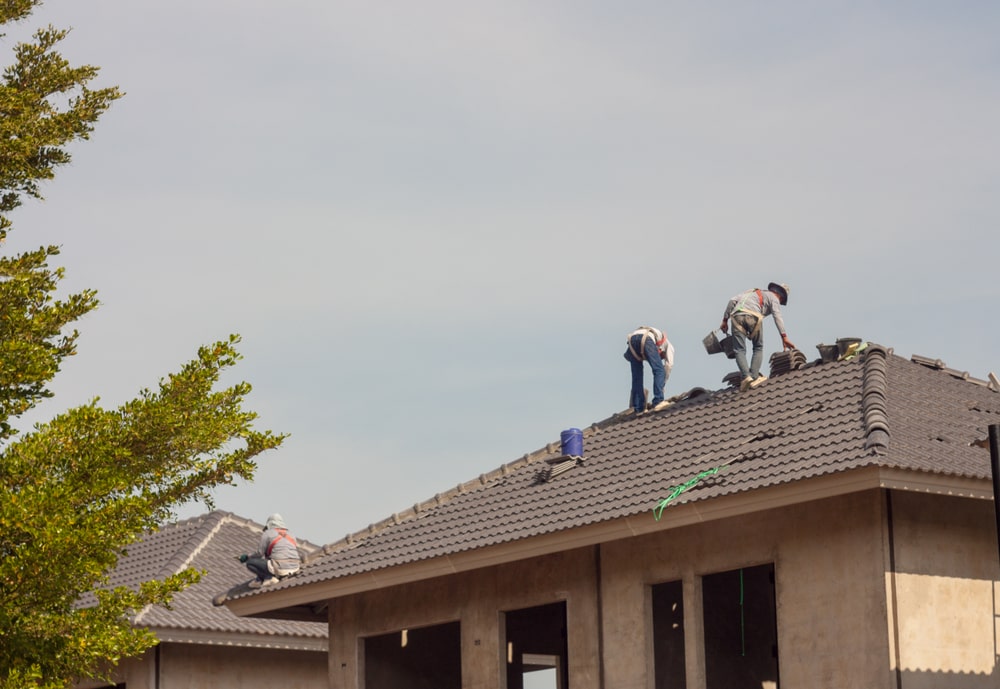 roofers working on a roof replacement